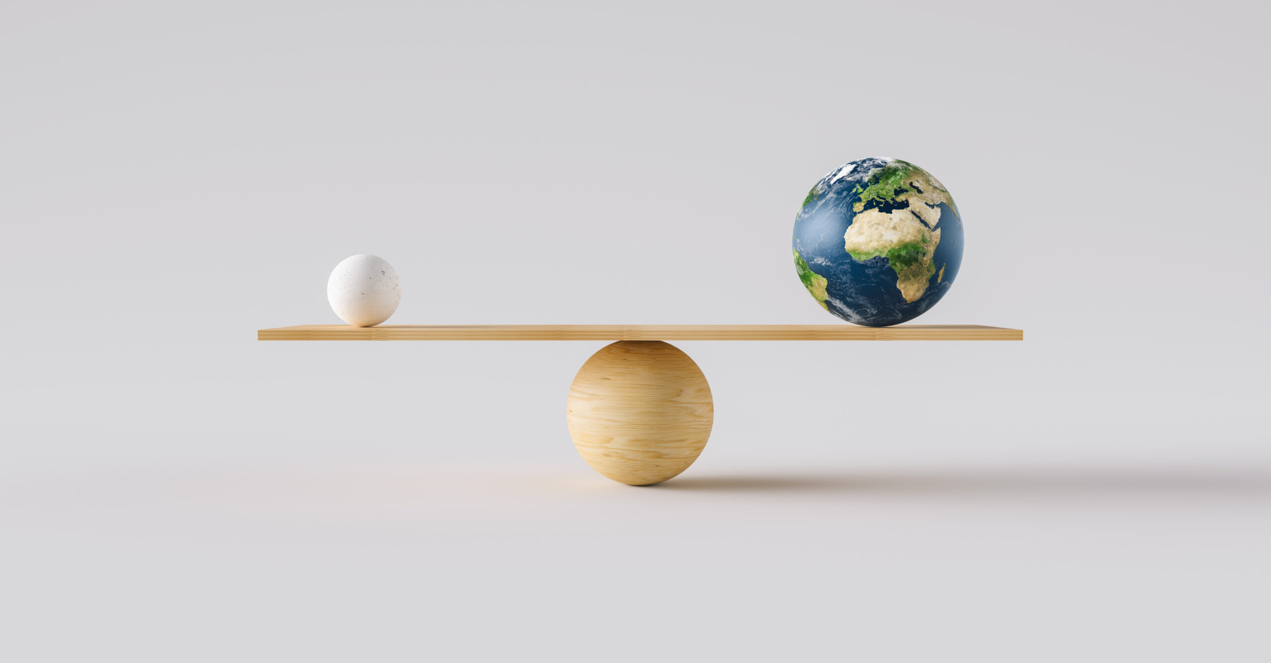 wooden scale balancing Earth ball and one small ball. Concept of