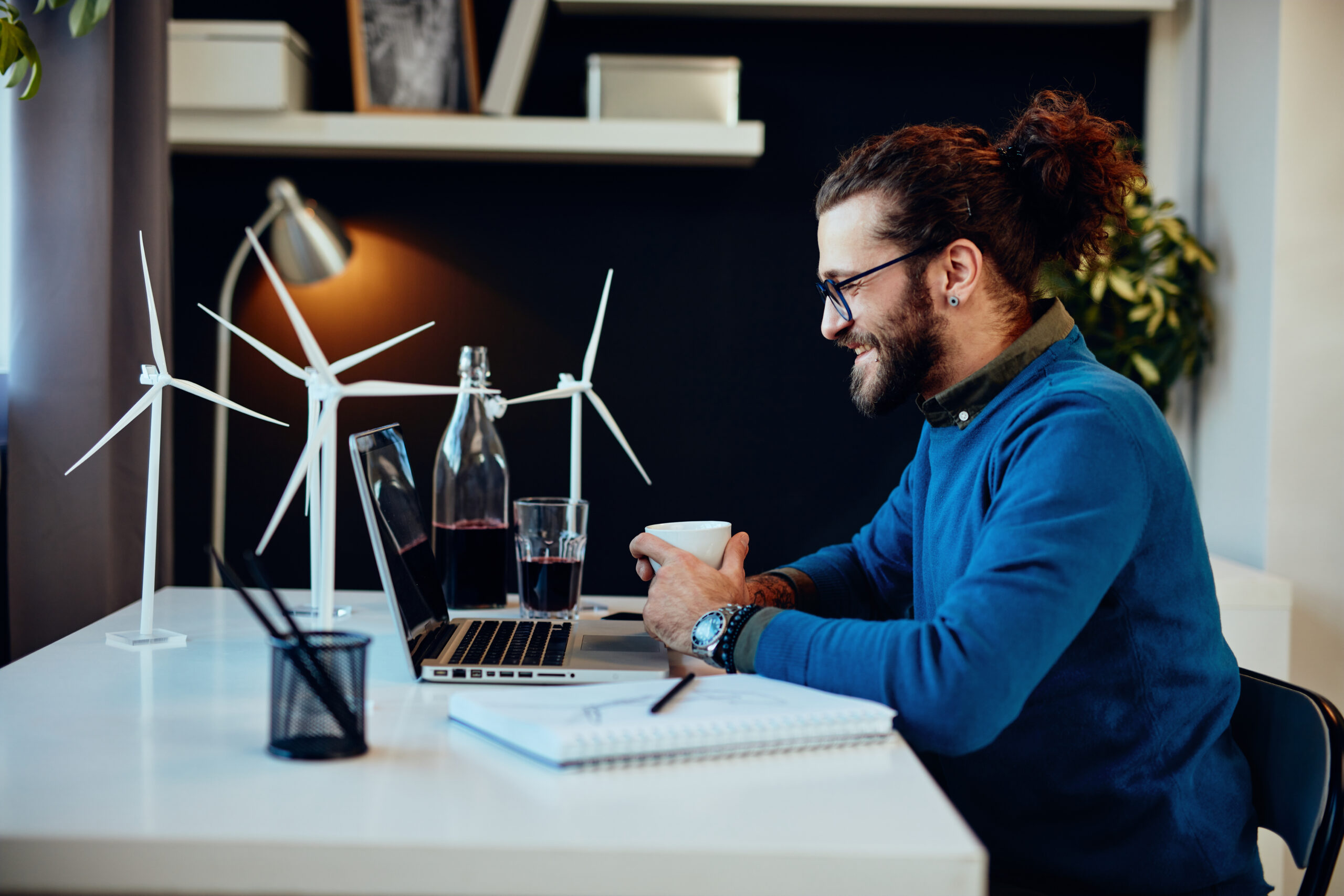 Charming caucasian freelancer sitting in his home office, typing